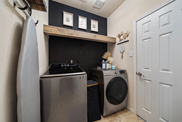 clothes washing area featuring washing machine and clothes dryer