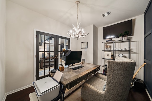 office featuring french doors, an inviting chandelier, and dark wood-type flooring