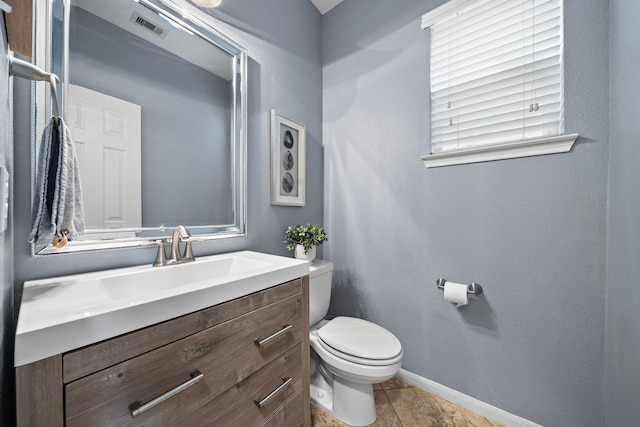 bathroom featuring vanity, toilet, and tile patterned flooring