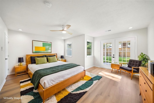 bedroom featuring light wood-type flooring, visible vents, access to outside, and french doors