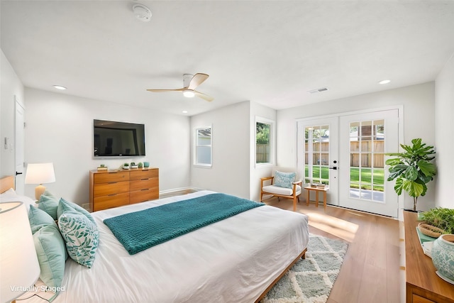 bedroom with hardwood / wood-style flooring, access to exterior, ceiling fan, and french doors