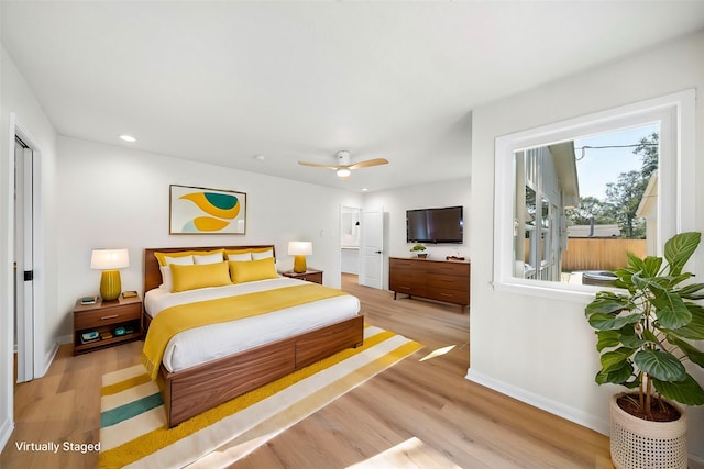 bedroom with light hardwood / wood-style floors and ceiling fan