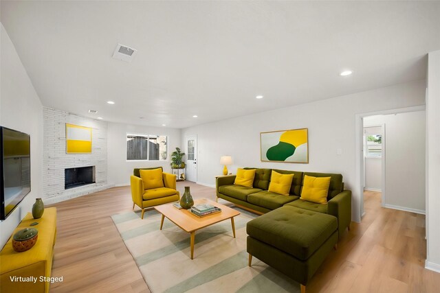 living room with a fireplace and light hardwood / wood-style floors