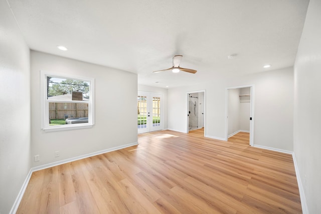 empty room with light hardwood / wood-style flooring, french doors, and ceiling fan