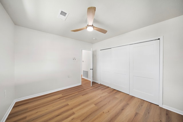 unfurnished bedroom with ceiling fan, a closet, and light wood-type flooring