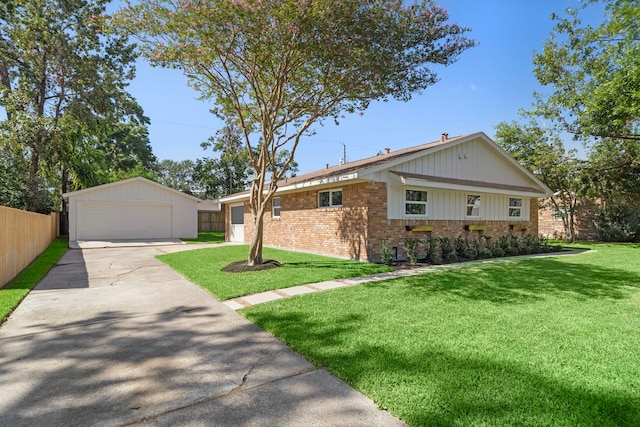 single story home with brick siding, a detached garage, a front lawn, fence, and an outdoor structure