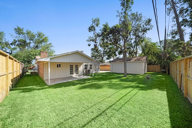 back of house with french doors, central AC unit, a patio area, and a lawn