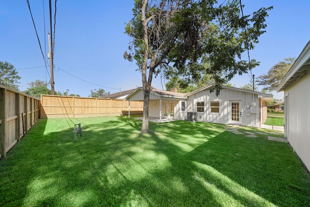 view of yard featuring central AC and a fenced backyard