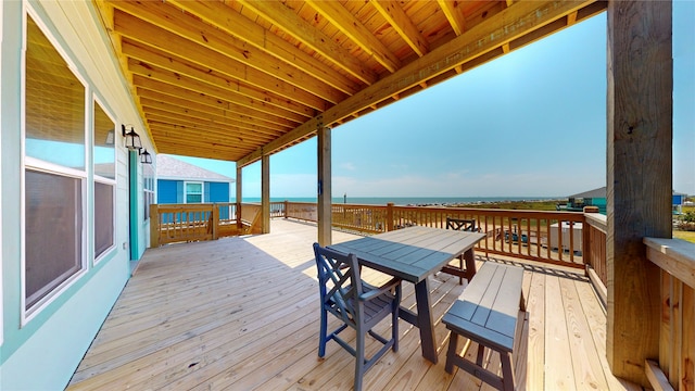 wooden terrace featuring a water view