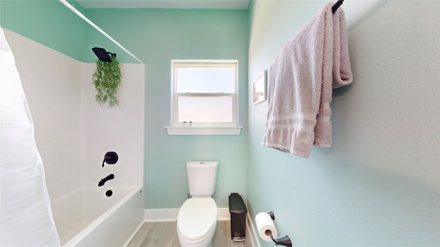 bathroom featuring wood-type flooring, toilet, and shower / bath combo with shower curtain