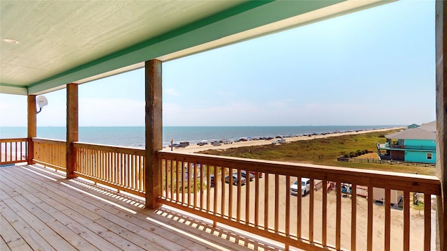 wooden terrace with a water view and a beach view