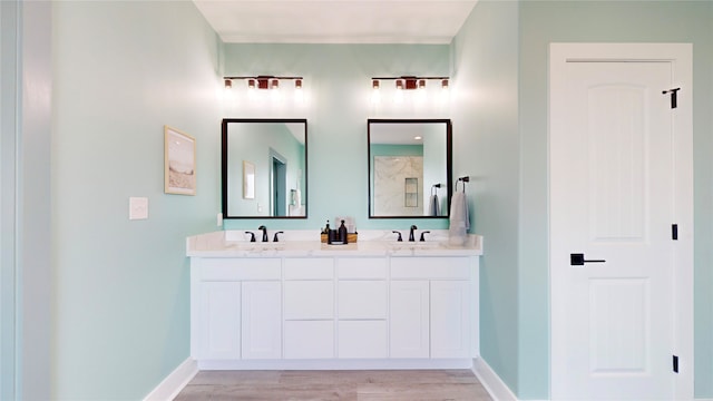 bathroom with vanity and hardwood / wood-style flooring