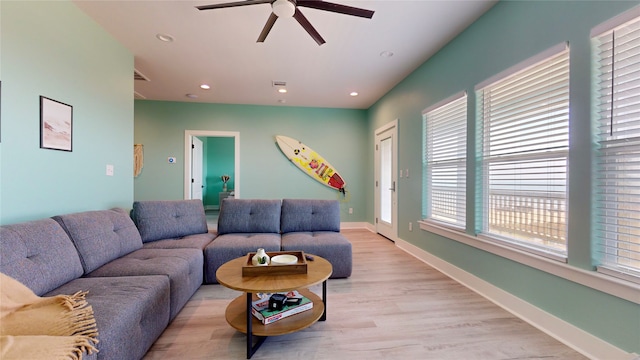 living room with ceiling fan and light hardwood / wood-style flooring