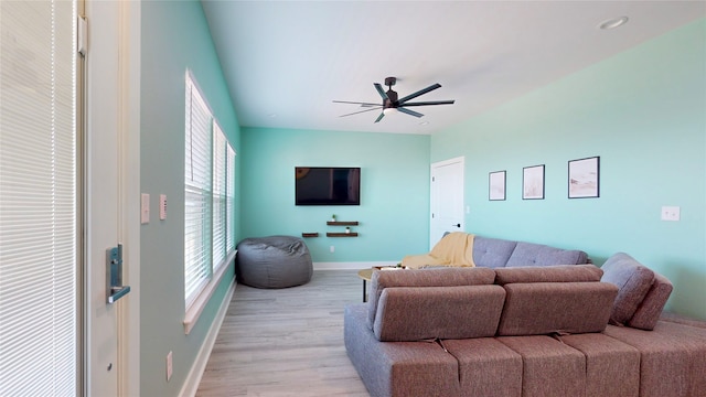 living room with ceiling fan and light wood-type flooring