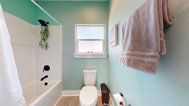 bathroom with shower / tub combo, hardwood / wood-style floors, and toilet