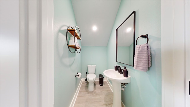 bathroom featuring hardwood / wood-style flooring and toilet