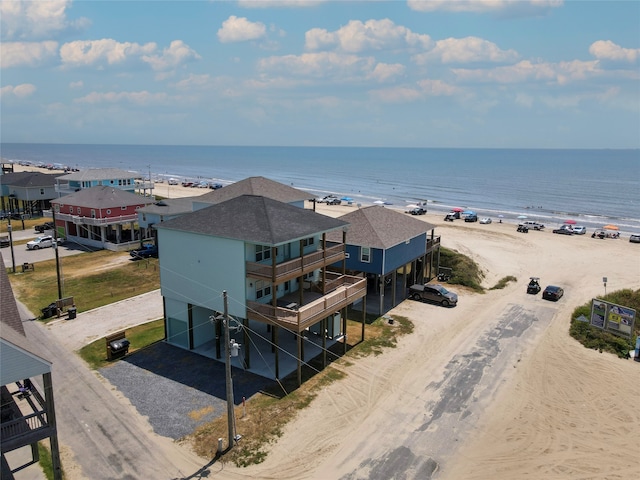 aerial view with a water view and a view of the beach