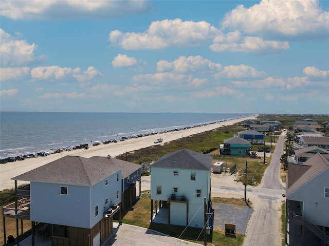 drone / aerial view with a water view and a beach view