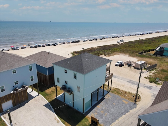 bird's eye view with a water view and a beach view