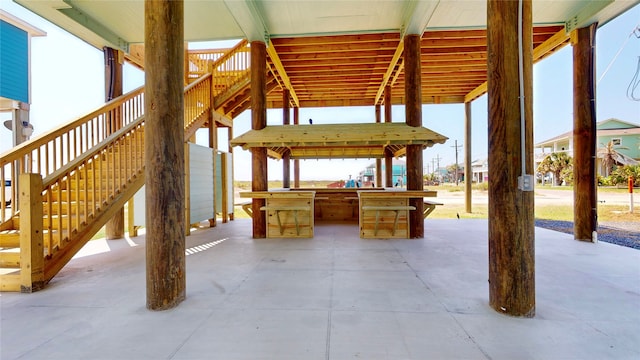 view of patio / terrace featuring outdoor dry bar and stairs