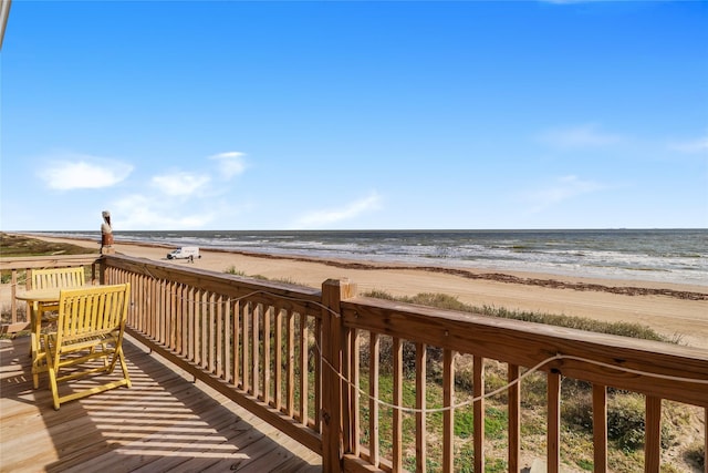 wooden terrace with a water view and a beach view