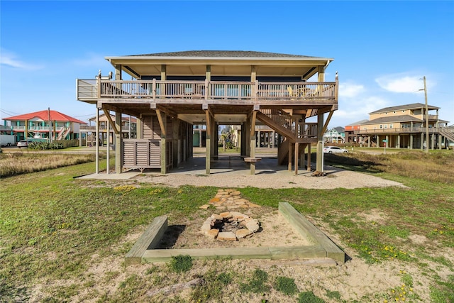 back of property featuring a deck, a patio, and a lawn