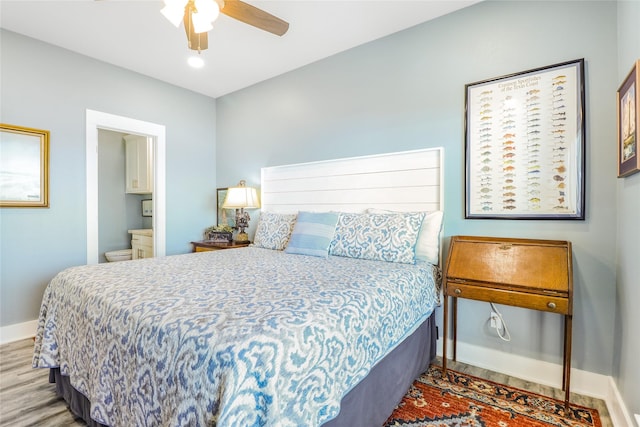 bedroom with wood-type flooring, connected bathroom, and ceiling fan