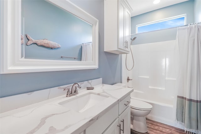 full bathroom featuring vanity, wood-type flooring, shower / bath combination with curtain, and toilet