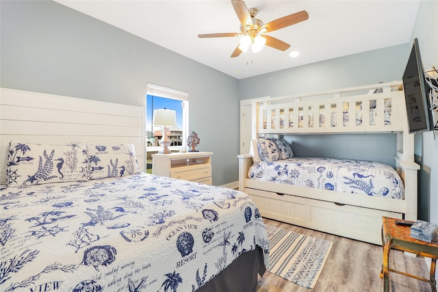 bedroom with ceiling fan and hardwood / wood-style floors