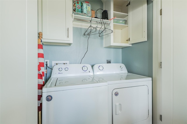 laundry area featuring cabinets and washing machine and clothes dryer