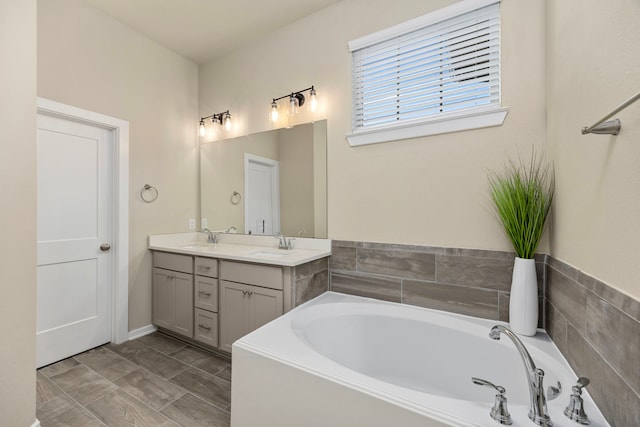 bathroom featuring vanity and a washtub