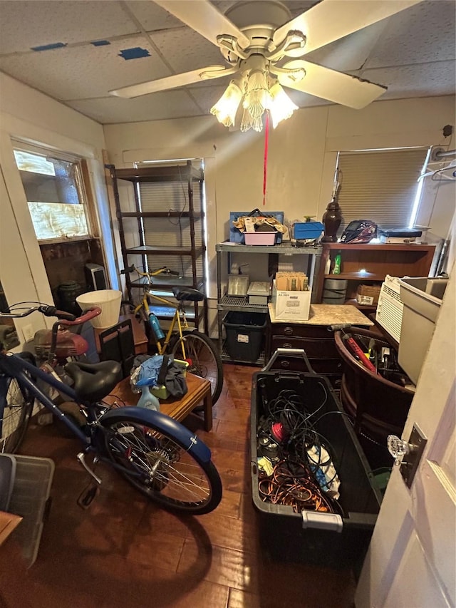 interior space with a drop ceiling and ceiling fan