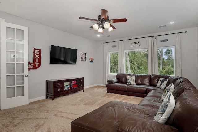 living room with light carpet and ceiling fan