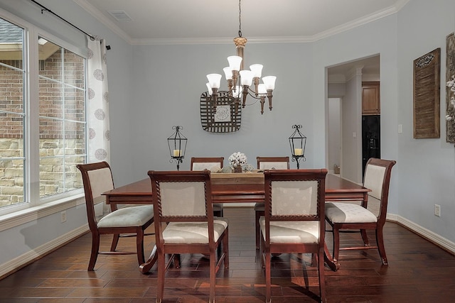 dining area featuring dark wood-type flooring, crown molding, and an inviting chandelier