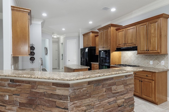 kitchen featuring light stone countertops, black appliances, range hood, and kitchen peninsula