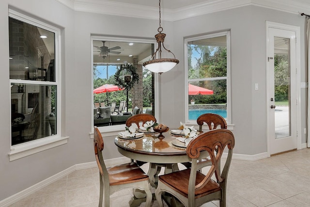 tiled dining room with a healthy amount of sunlight and ornamental molding