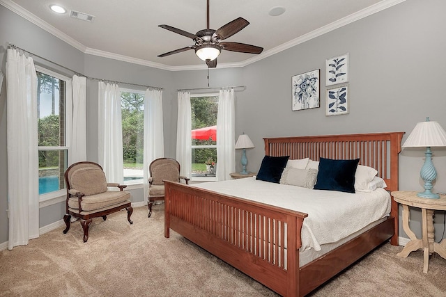 carpeted bedroom featuring ornamental molding and ceiling fan