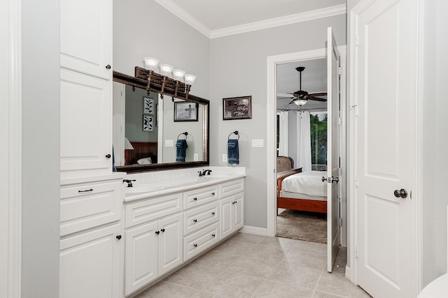 bathroom with crown molding, tile patterned floors, and vanity