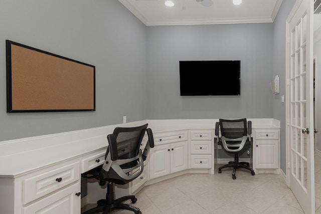 home office with crown molding, built in desk, and light tile patterned flooring