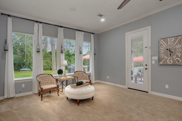 sitting room featuring light carpet, plenty of natural light, and ornamental molding