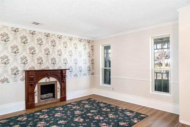 living room featuring wood-type flooring, crown molding, and a textured ceiling