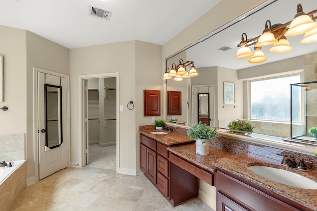 bathroom featuring tiled tub and vanity