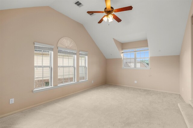 bonus room with vaulted ceiling, light colored carpet, and ceiling fan