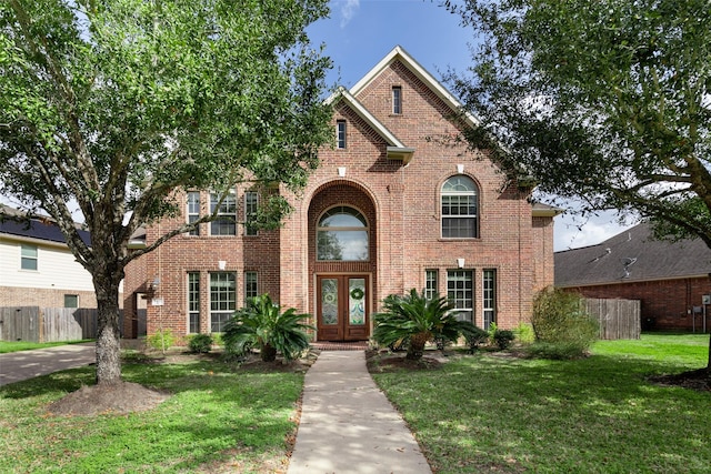 view of front of house with a front yard and french doors