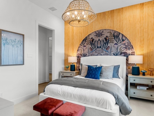 carpeted bedroom featuring a chandelier