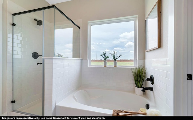 bathroom featuring separate shower and tub