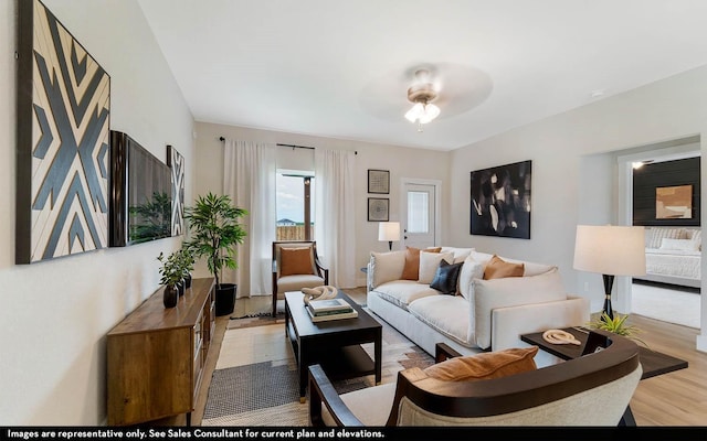 living room featuring ceiling fan and light wood-type flooring