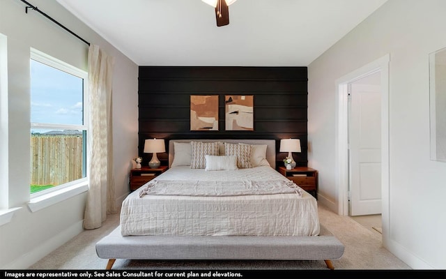 bedroom featuring light carpet and ceiling fan