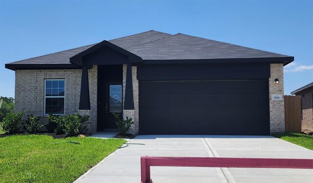 926 Alaska Cedar Dr, Crosby, TX 77532 - ranch-style house with an attached garage, concrete driveway, roof with shingles, and a front yard