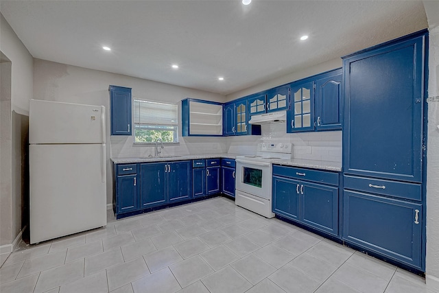 kitchen with light stone counters, sink, white appliances, and blue cabinets